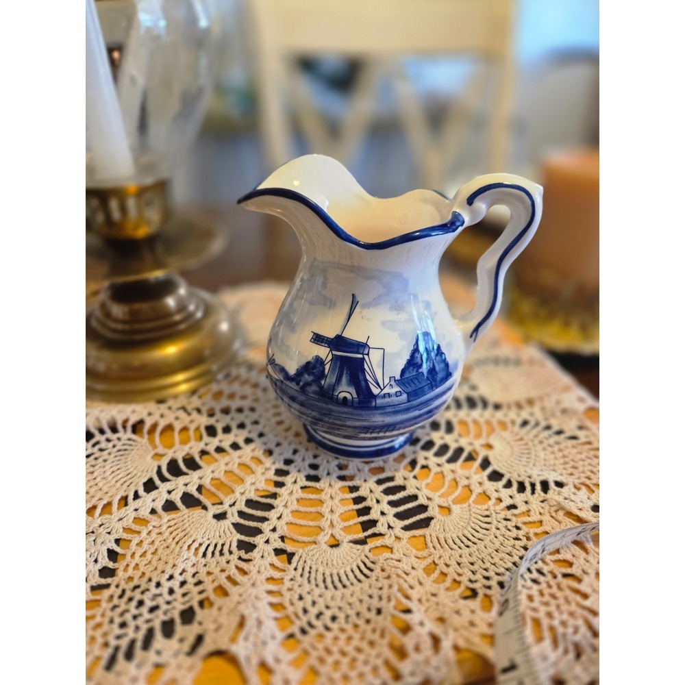 This is a vintage Delft Blue hand-painted ceramic creamer pitcher And Bowl/plate
